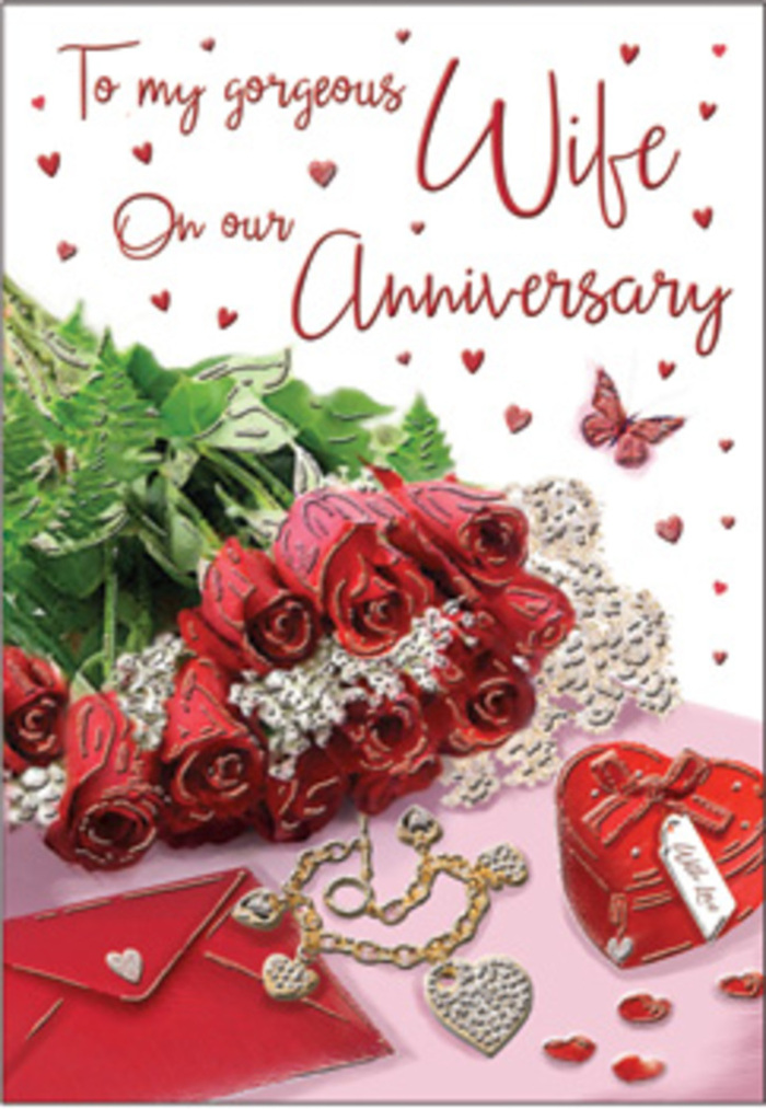 A richly romantic anniversary arrangement is captured in this image, as if styled by a South Woodford florist preparing a surprise delivery before dusk. At its heart lies a bouquet of classic red roses, luxuriously full and perfectly opened, each bloom layered with petals that curl outward in soft spirals. Their colour is a deep, confident crimson, enhanced by bright green leaves and sprigs of foliage that fan out in gentle arcs, suggesting freshness and life. The roses rest beside an elegant greeting card and its companion envelope, both positioned slightly askew to create a relaxed yet intentional composition, like a love note set down on a table near Epping Forest after a romantic walk. Dotted around this focal point are decorative treasures: a small red heart-shaped box that could cradle jewellery, a fine necklace with interlocking heart charms, and perhaps earrings or a bracelet placed just within reach. Tiny hearts, some glossy, others more subtle, are scattered over the background, echoing the theme of affection that runs through the scene. A single butterfly motif, delicate and poised, seems to hover near the petals, adding a sense of freedom and quiet joy. Soft, diffused lighting smooths away any harsh edges, bathing the reds, golds, and creams in a warm, inviting glow. The entire tableau conveys intimacy and thoughtfulness, like an anniversary surprise waiting in a South Woodford home: roses that suggest lasting passion, keepsakes that speak of shared history, and a card that holds the words two people have grown into over many loving years.