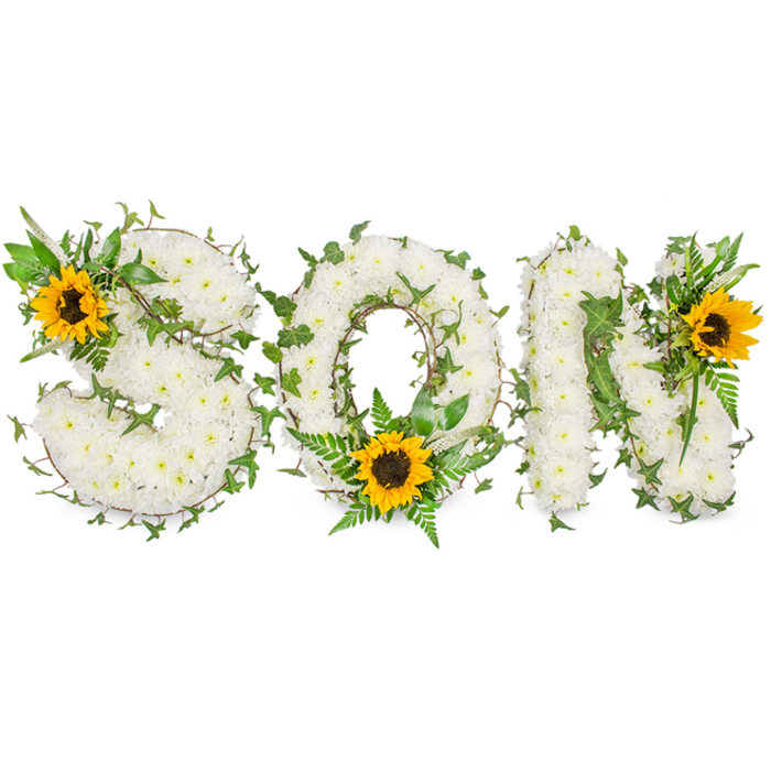 An expertly crafted memorial piece presents the letters S, O and N in a horizontal, three-dimensional formation, each letter densely carpeted with immaculate white chrysanthemums that form a soft, cloud-like texture. The chrysanthemums' small heads are closely placed so the letter shapes read clearly from a distance yet reveal delicate petal detail on closer inspection. Interlaced throughout the white floral ground are strands of dark green ivy and delicate tendrils, their glossy leaves adding sculptural lines and a sense of perennial life. Additional foliage-lighter green fern fronds and pointed leaves-is strategically layered to create depth, subtle shadowing, and a natural, garden-like scent beneath the sweeter chrysanthemum aroma.
To lift the palette, three large sunflowers with golden-yellow petals and pronounced dark brown centres are positioned as focal accents: one on the upper-left curve of the S, one at the lower curve of the O framed by feathery ferns, and one at the upper-right corner of the N. Photographed against a stark white background with even, soft lighting, the arrangement's textures and color contrasts read vividly-the cool whites, deep greens and warm sunflower gold combining to convey respect, remembrance and a gentle optimism. This bespoke tribute would be chosen by families in South Woodford and neighbouring Woodford Green when honouring a beloved son, a calm and dignified statement of love and memory.
