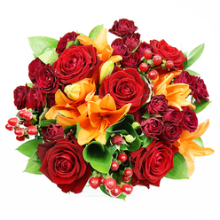 Captured from above on a pristine white surface, this rounded bouquet feels both opulent and approachable, the kind of arrangement you might choose for an anniversary or a heartfelt thank-you in South Woodford. Large, fully opened deep red roses anchor the piece, their velvety petals folding inward like soft cushions around warm centres; interspersed are vivid orange Asiatic lilies whose trumpet shapes and visible stamens bring a bright, celebratory rhythm to the design. Smaller burgundy spray roses punctuate the palette with concentrated pools of colour, while clusters of glossy hypericum berries add playful, tactile highlights that catch the light and lift the overall composition. Fresh, broad green leaves-salal or ruscus-peek between blooms, giving the bouquet volume and a cool, leafy counterbalance that enhances the flowers' warmth and scent. The soft, diffused lighting in the photograph flattens shadow without losing texture, so each petal and berry reads clearly in the top-down view, emphasising careful placement and craftsmanship. As a florist who knows the little corners of town from George Lane's shops to the paths of Epping Forest, I imagine this bouquet being gathered early in the morning, flowers still cool and just-cut, then delivered across South Woodford; at Flower Delivery South Woodford we favour this rich red-and-orange combination for romantic gestures or autumn celebrations because it reads both timeless and joyful. The overall impression is intimate abundance-a bouquet that radiates warmth, passion and thoughtful care.