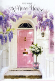 The photograph portrays a tender, dreamlike entrance to a new home in South Woodford, imbued with quiet joy and understated romance. Center stage is a pale pink door, smooth and subtly luminous, the kind of shade that glows warmly in late-afternoon light reflecting off the nearby homes around The High Road. The frame around it is finished in clean white plaster, slightly dappled, with a single pastel shutter echoing the door's gentle hue and adding balance to the composition. Above, lush strands of lavender wisteria pour downward in relaxed cascades, creating a floral arch that softens every edge and suggests a delicate perfume drifting on the air, like the first breaths of spring near Roding Valley Park. Just at the foot of the door, a simple silver-grey bucket sits on the step, transformed into a luxurious vessel for a florist's carefully crafted arrangement. It overflows with plush white and cream roses, their petals layered and soft, some opening wide in full, fragrant generosity, others offering just a hint of what's to come. Wisps of fresh greenery weave among the roses, providing contrast and a touch of natural movement, as if stirred by a passing breeze. A pink satin ribbon is tied around the bucket, its loose ends resting lightly on the stone, adding a final note of tenderness. The entire scene feels like a story of arrival and welcome, the kind of doorstep you might find after a same-day delivery from a local South Woodford florist, celebrating a move, a new chapter, or simply the comforting feeling of finally coming home.